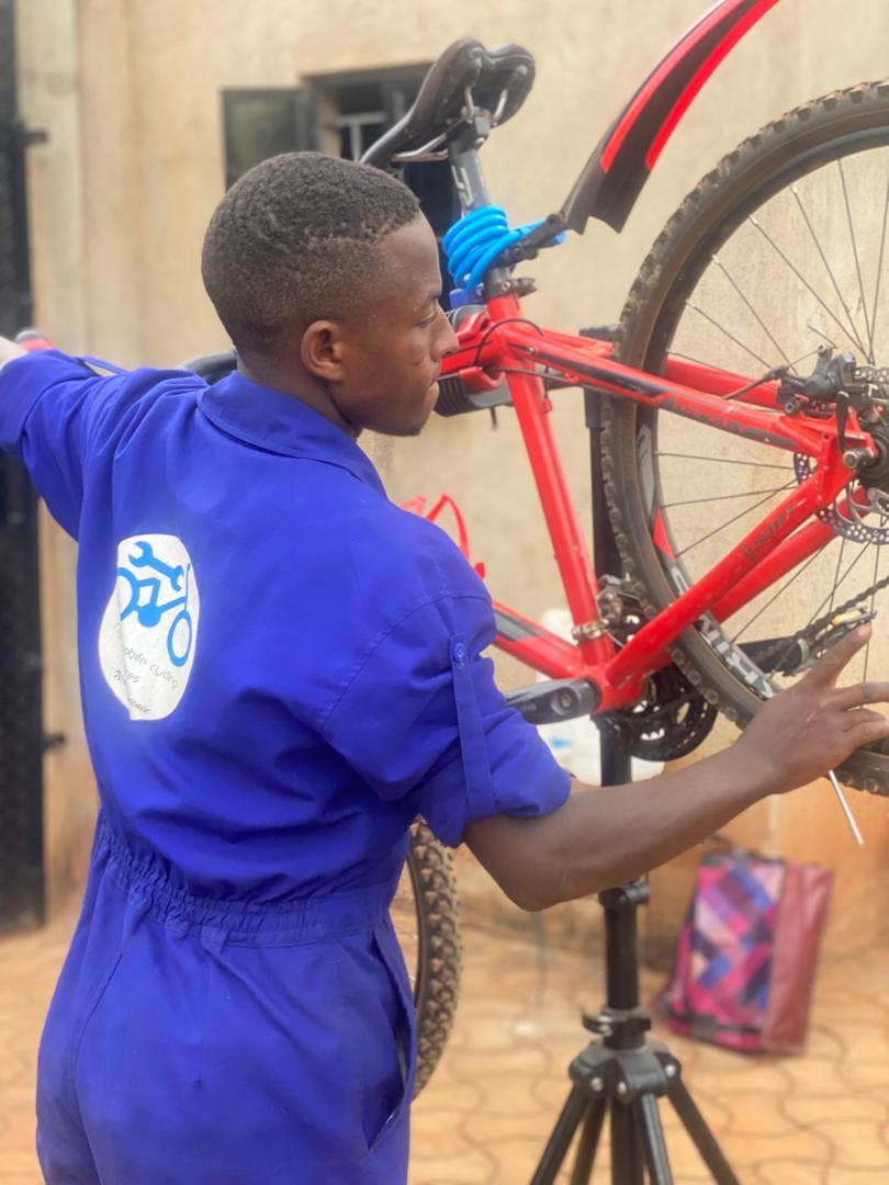 Ngalo mechanic servicing a bicycle wheel
