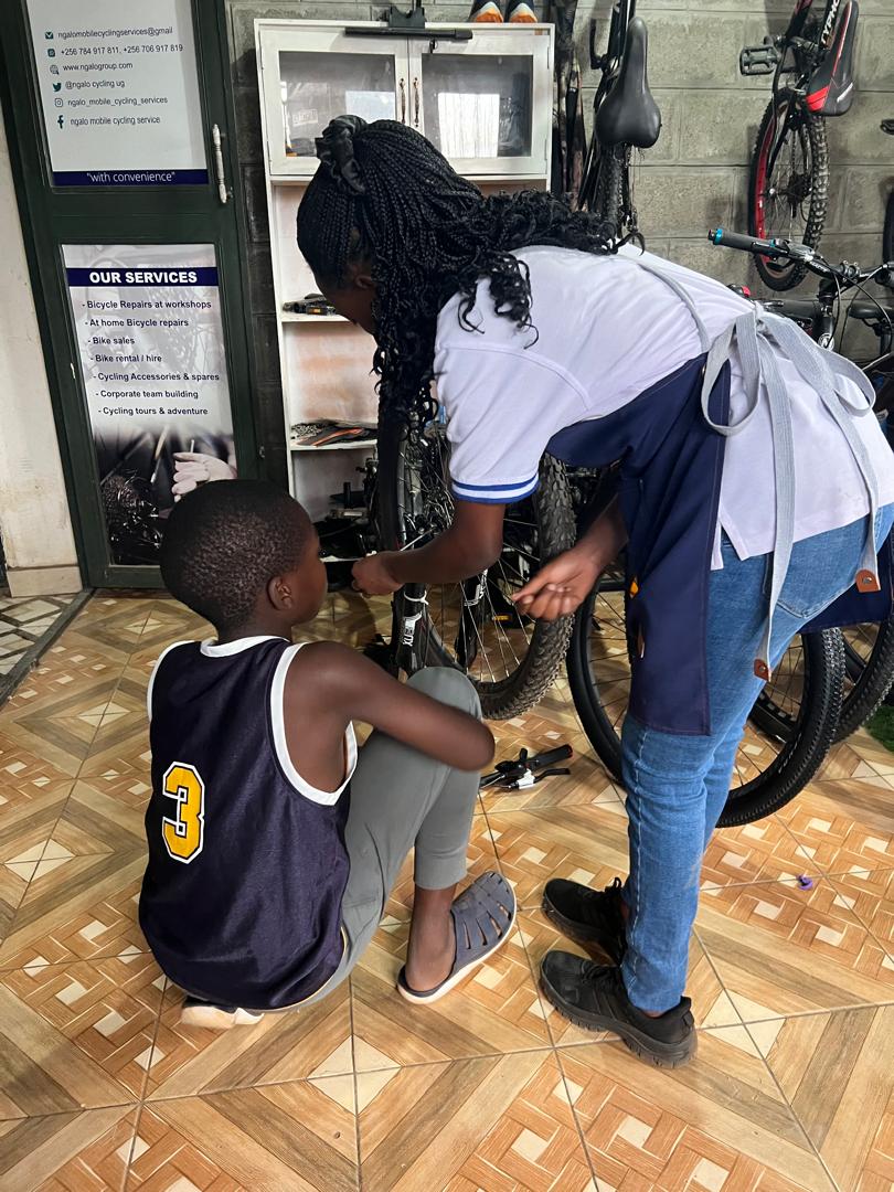 Mechanic servicing a bike on a repair stand